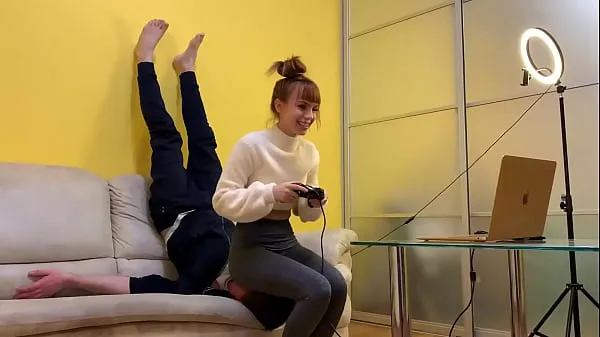 Meilleurs Gamer Girl Kira en leggings gris utilise son esclave de chaise tout en jouant pendant un facesitting de poids plein (aperçu méga-clips